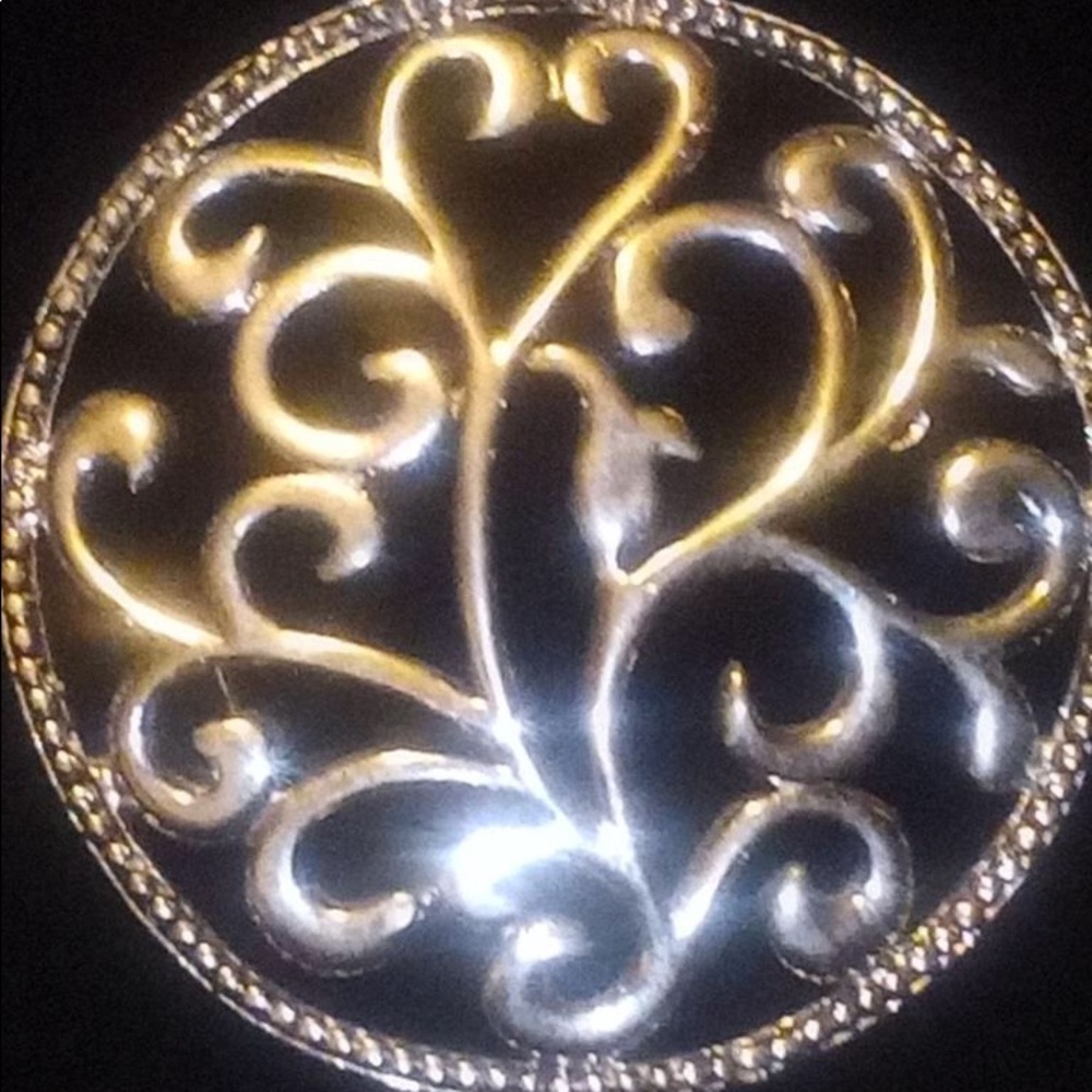 Round pendant with heart shapes inside